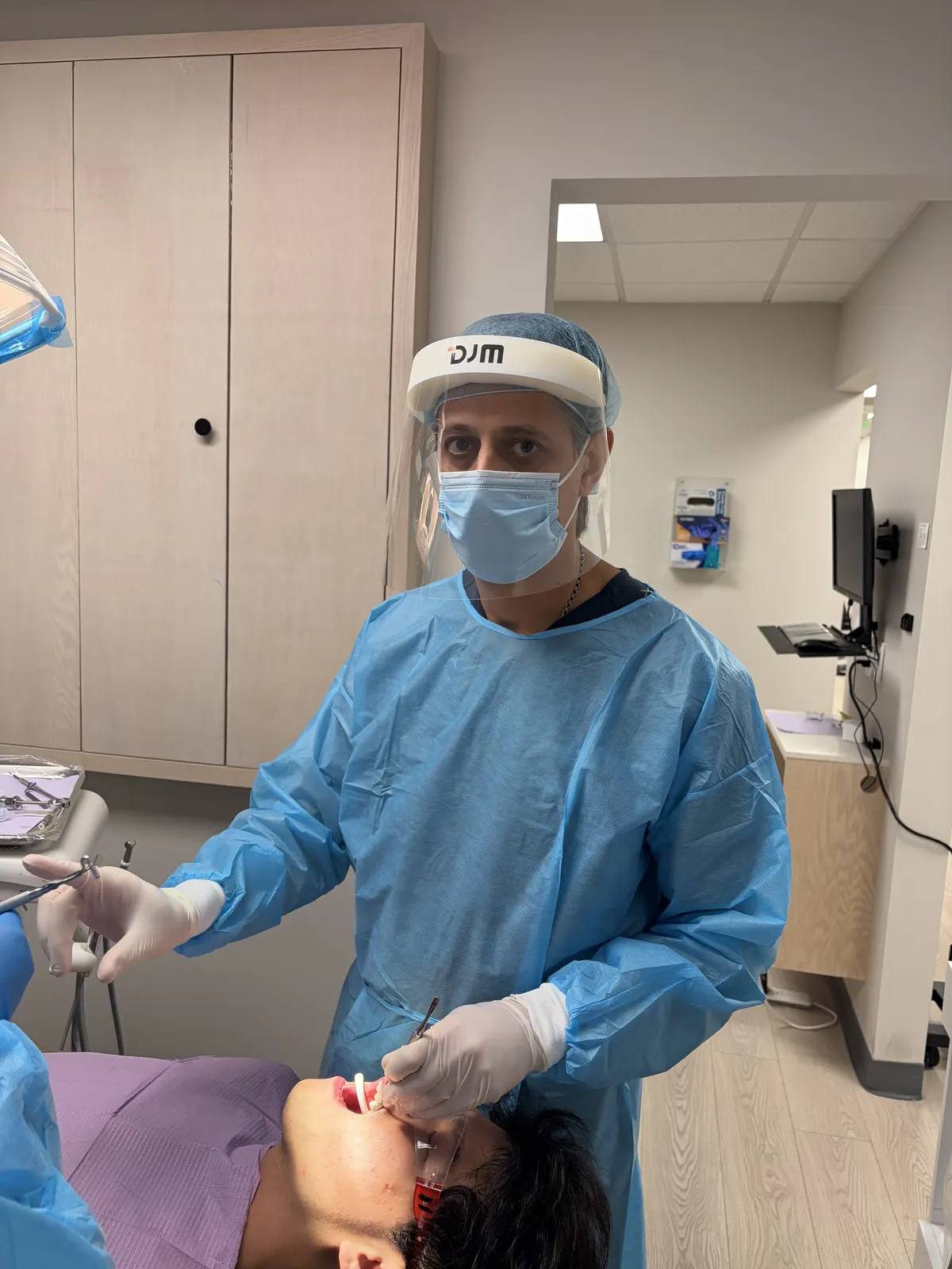 Dental professional examining patient's gums during periodontal evaluation