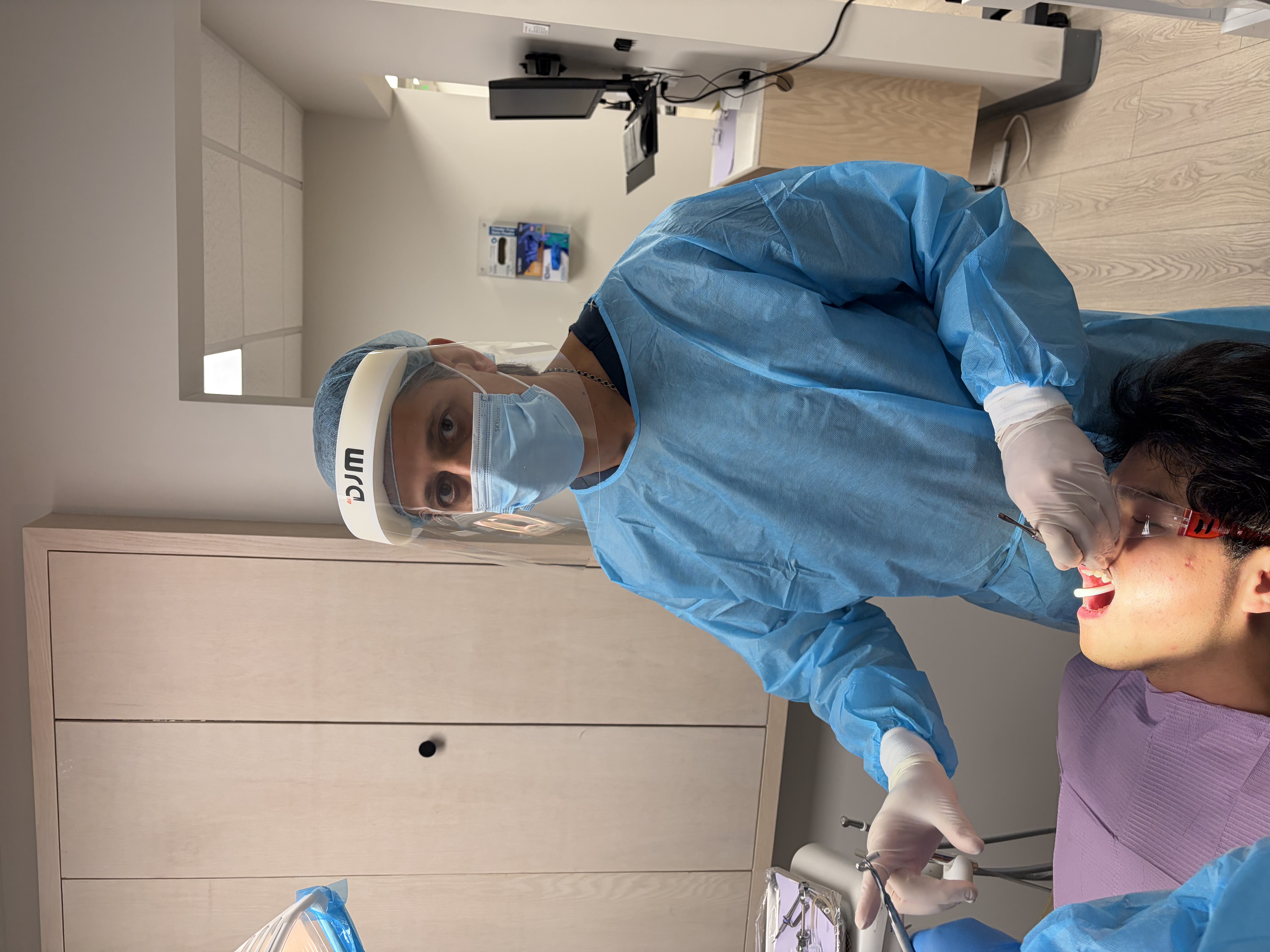 Dental professional examining patient's gums during periodontal evaluation