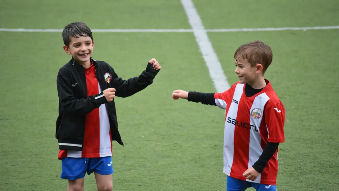 Two young soccer players on the field, the kind of contact sport where a mouthguard protects teeth