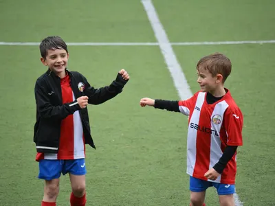 Two young soccer players on the field, the kind of contact sport where a mouthguard protects teeth